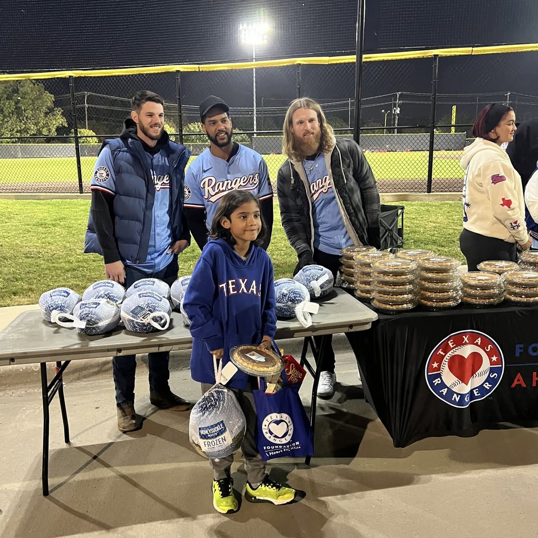 Jonah Heim, Taveras, and their colleagues at the Texas Rangers served over 250 Thanksgiving meals to those in need in the DFW area with bright smiles